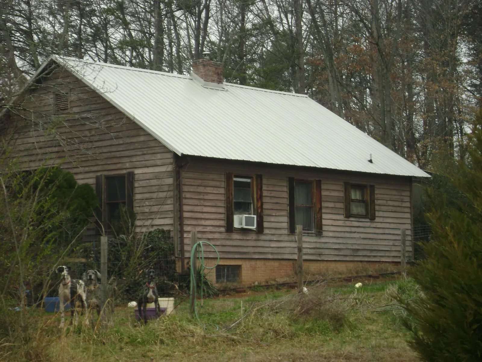White metal roof on an old wood sided farmhouse, from a Metal Roof Installation job in Antwerp
